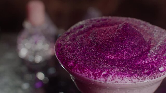 Colored foam on a cocktail drink in a glass