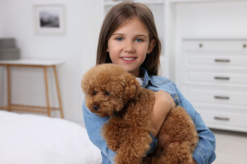 Little child with cute puppy at home. Lovely pet