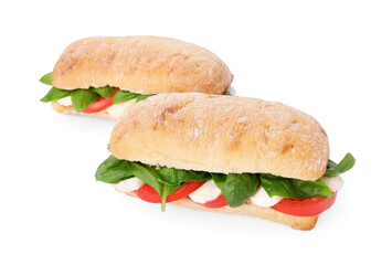 Delicious Caprese sandwiches with mozzarella, tomatoes and basil isolated on white