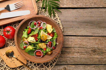 Delicious salad with peach, green peas and vegetables served on wooden table, flat lay. Space for text