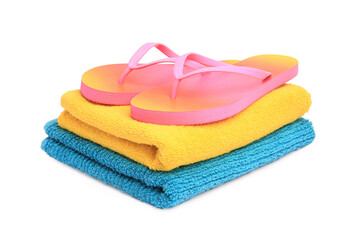 Colorful terry towels and flip flops isolated on white. Beach objects