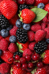 Obraz premium Different fresh ripe berries as background, top view