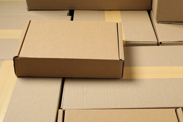 Many cardboard boxes as background, closeup. Packaging goods