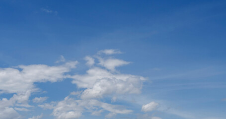 Obraz premium Blue sky fluffy white clouds on summer season bright clear skyline with beautiful cloudscape. Panorama blue sky clouds pattern on daylight with copy space. Cumulus cloudscape air climate sunny day