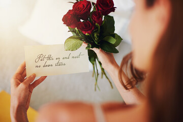 Woman, roses and note with gift in bedroom on birthday, celebration and valentines day event in...