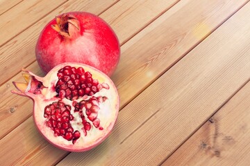 Pomegranate fruit sliced with seeds, food concept