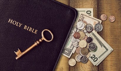Holy Bible book and money coins