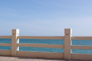 Stone guardrail on walkway and sea view