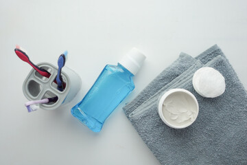 mouthwash liquid and toothbrush on white background 