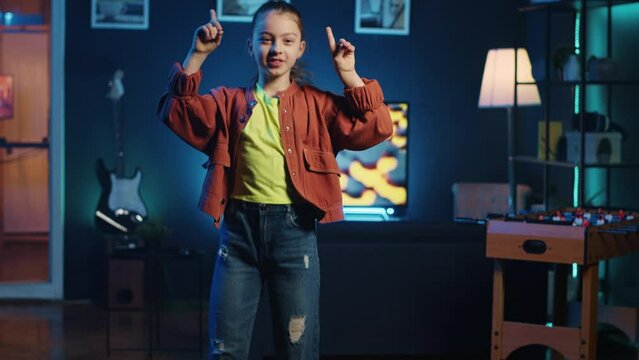 Children content creator using professional recording equipment to film dancing video for online streaming platforms. Young media star does viral choreography for her generation z fanbase