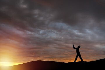 Fototapeta premium Person on sunset sky with number 2024 background.