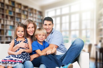 Happy young parents and kids resting at home