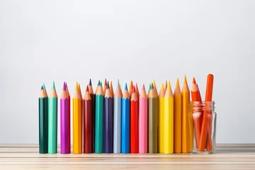 Fotobehang Colorful pencils in glass jar on wooden table. Back to school concept. © StockHaven