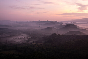 High mountains a beautiful sky at a sunset viewpoint and a lot of water vapor create a sea of mist