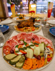 dinner table in an Italian restaurant in Thailand, antipasti with roasted pork and pizza