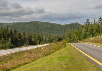 Fototapeta na wymiar Road to Gros Morne National Park in western Newfoundland with green forest and mountains