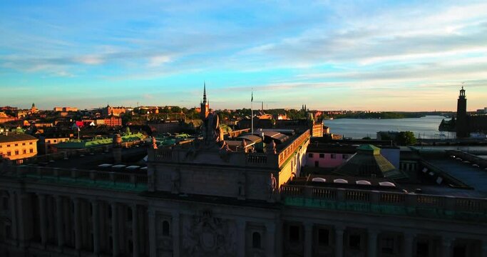Aerial Backward Shot Statue On Government Building In City During Sunset Against Sky - Stockholm, Sweden