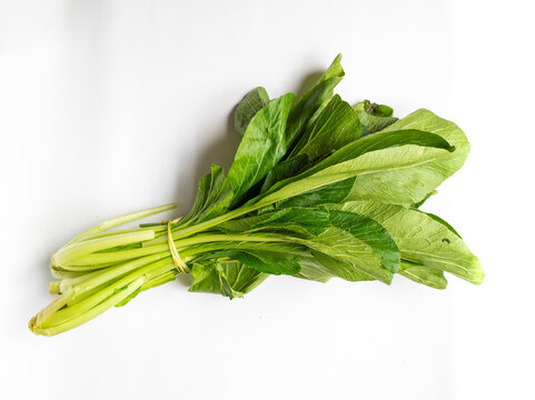Fresh caisim isolated with white background.