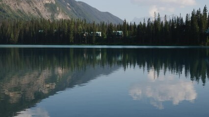 Serene Lake Reflection with Forest and Mountain View at Dusk