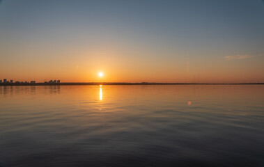 Naklejka premium Lake with pine and birch forest on the shores at summer or early autumn sunset.