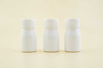 Mockup of medical skin care bottle cosmetic tube of tablet of pill isolated on cream background