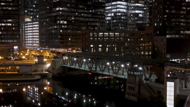 Train moving over the illuminated Lake Street Bridge, night in Chicago, USA