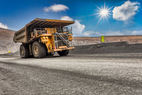 heavy truck , at the open pit diamond mine carry a kimberlite load uphill the dirt road