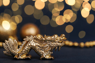 Golden dragon symbol of the year 2024 on a dark background