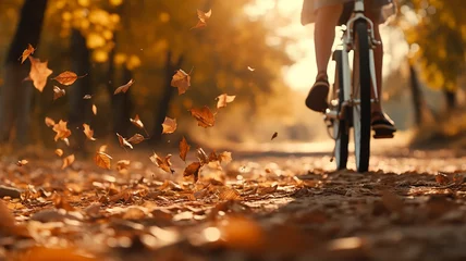 Foto op Canvas bicycle in motion autumn background wheels leaves flying in autumn park fall sunny day © kichigin19
