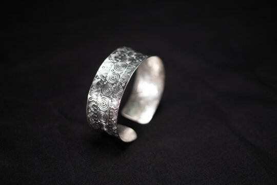 Hmong silver jewelry on black background, Handmade silver accessories