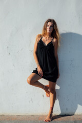 Beautiful slender woman in black summer dress