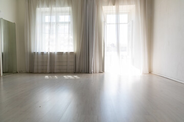 Interior of a white empty room with a large window