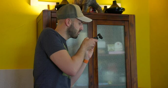 Videographer filming with new DJI Osmo Pocket 3 stabilized 3-axis mobile gimbal camera in house room