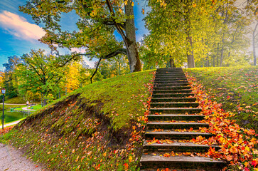 Staircase leading on the hill in old autumn park - 677999111