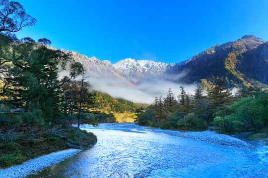 The clear stream of Azusa River and snow capped Hotaka mountain range from Kappa-bashi bridge in Autumn in Kamikochi , Japan,Nagano Prefecture,Matsumoto, Nagano October 2018