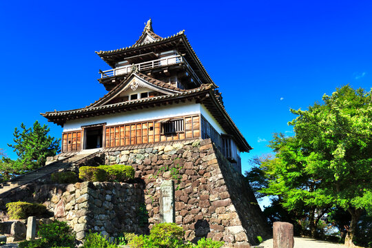 Hokuriku Maruoka Castle keep and the moon in a clear sky , Japan,Nagano Prefecture,Matsumoto, Nagano September 2020
