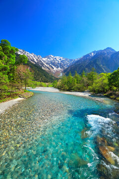 Clear stream of Azusa River and lingering snow on the Hodaka mountain range from Kappa-bashi Bridge in Kamikochi , Japan,Nagano Prefecture,Matsumoto, Nagano May 2022