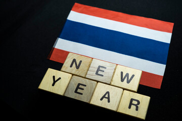 Fototapeta na wymiar New year to Thailand people with Thailand flag on banner