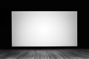 an empty white screen on a wooden stage in a 3d movie theater black and white photo
