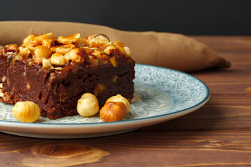 Brownie cake with chocolate and hazelnuts on plate