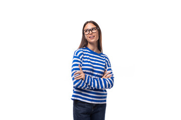 portrait of a European pretty brunette young lady in a casual striped sweater and jeans on a white background. people lifestyle concept