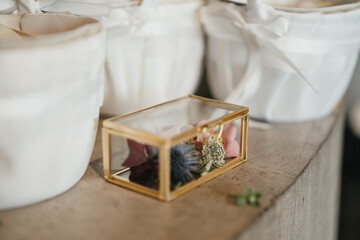 Golden box for rings decorated with colorful flowers