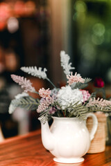 Dried flowers in white vases on the tables in the restaurant add to the beauty. Home decoration ideas.
