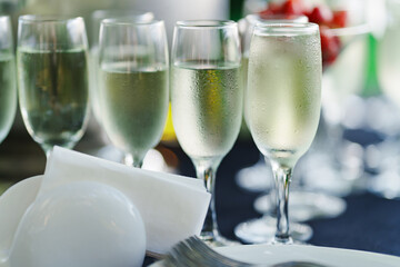 Champagne glasses on the buffet table. Table setting for a buffet at a party. 