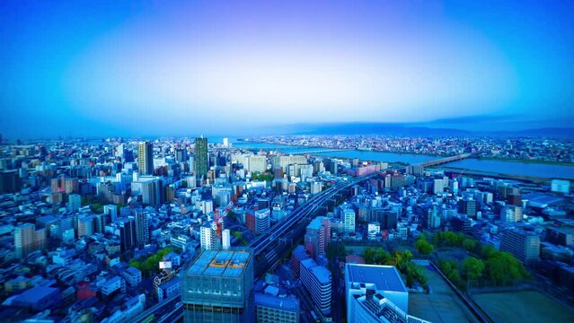 A dawn timelapse of panoramic cityscape near Yodo river in Osaka tilt