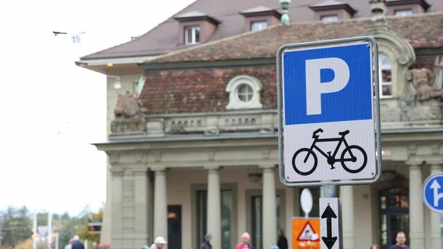 Bicycle parking sign in city center, isolated with blurred background