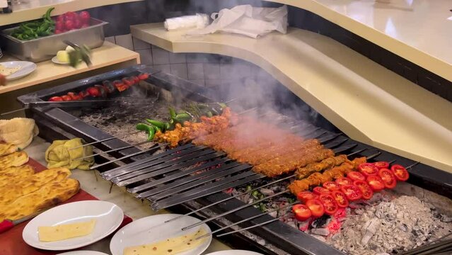 Prepare cook on fire Turkish Cuisine Persian Food barbecue BBQ kebab roasted tomato beef steak Istanbul Turkish Traditional Adana Kebab Barbecue Close Up scenic beautiful mouth watering local tasty