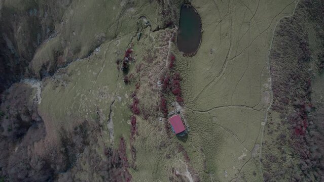 Drone flight over Mt Miune in Shikoku, Japan during Autumn. The mountains shows high contrast of green and red leaves.