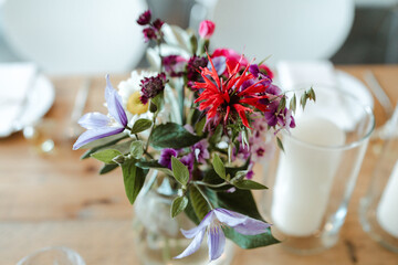 Colorful flowers in a transparent glass vase at a wedding loaction