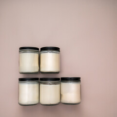 five white candles on a mauve background